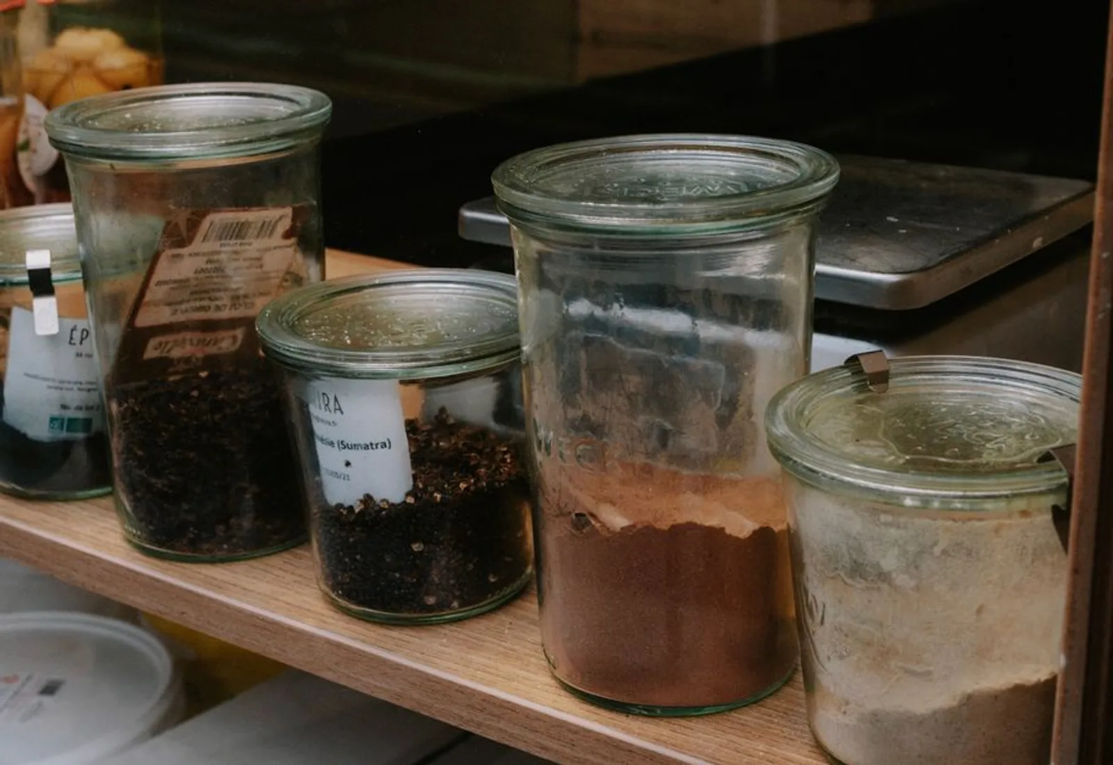 Glass jars of coffee lined up on a shelf