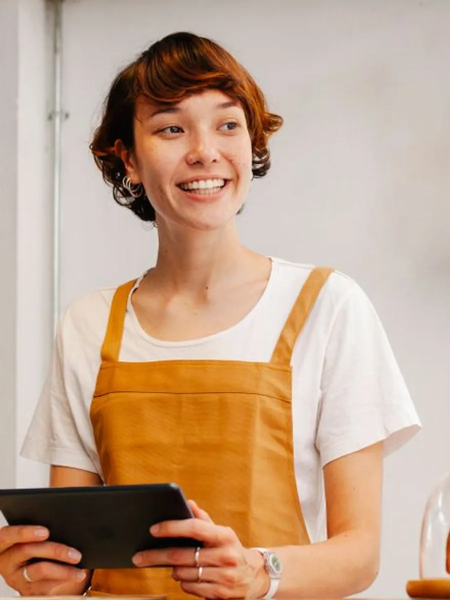 Elena, green buyer, smiling in an apron