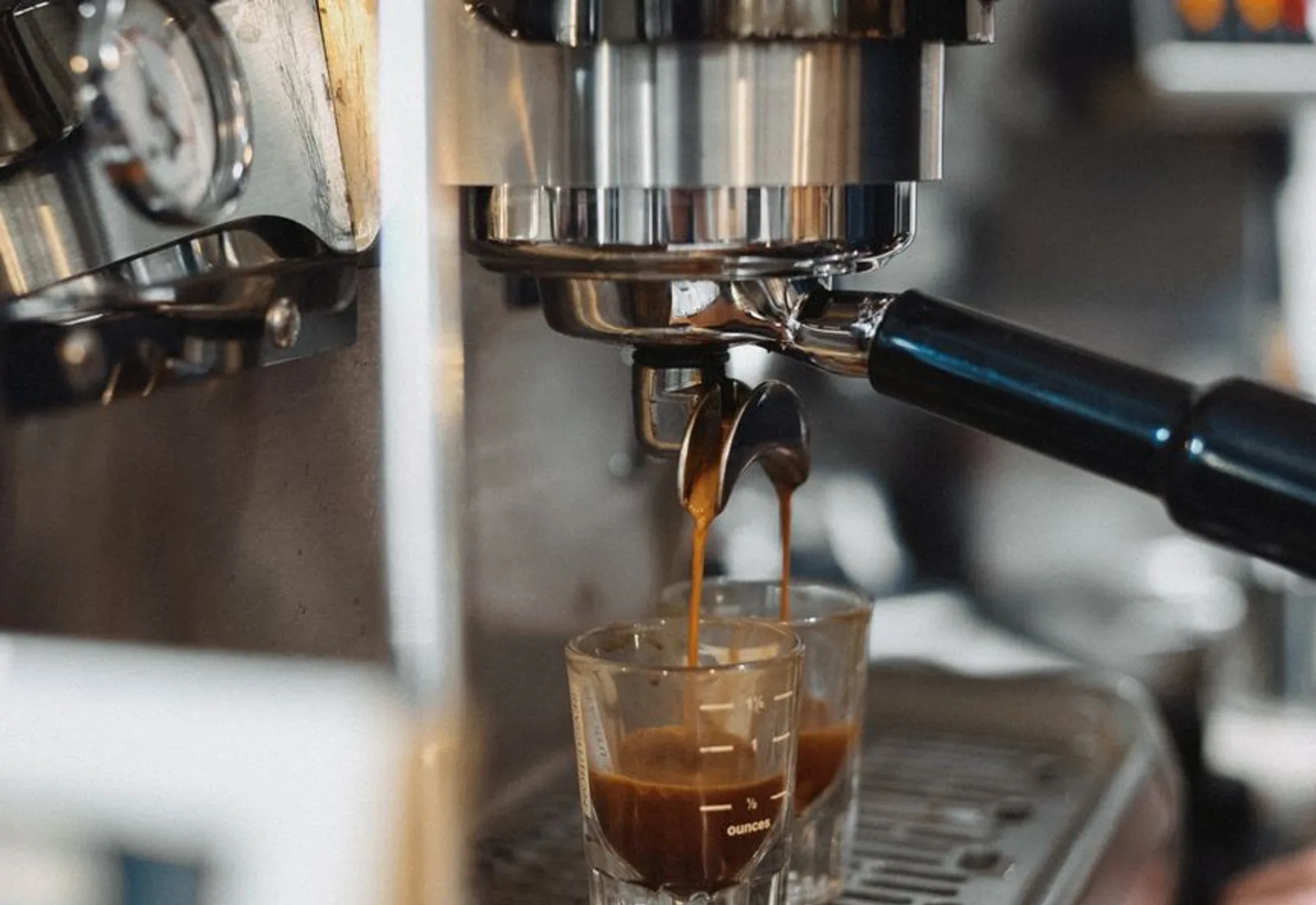 Espresso pulling into a glass under the group head