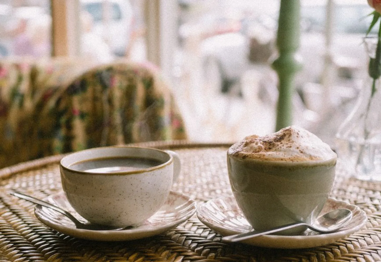 Cups and saucers set out across a table for a tasting