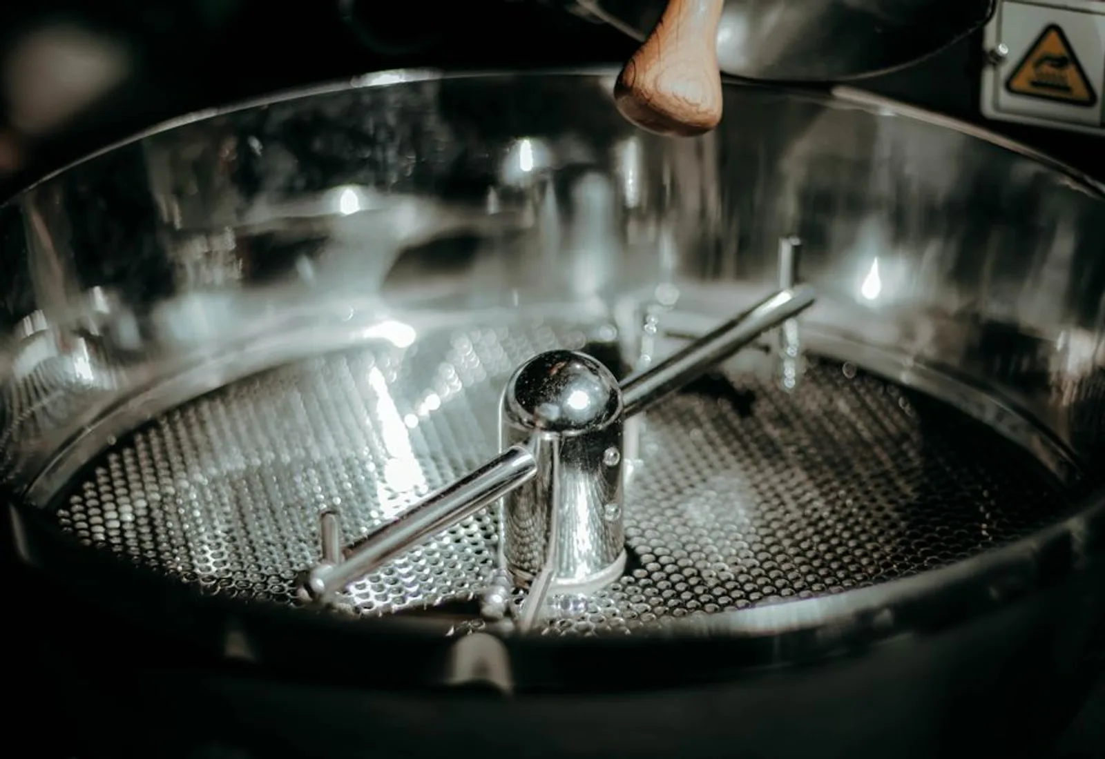 The drum roaster mid-roast, beans turning behind the glass