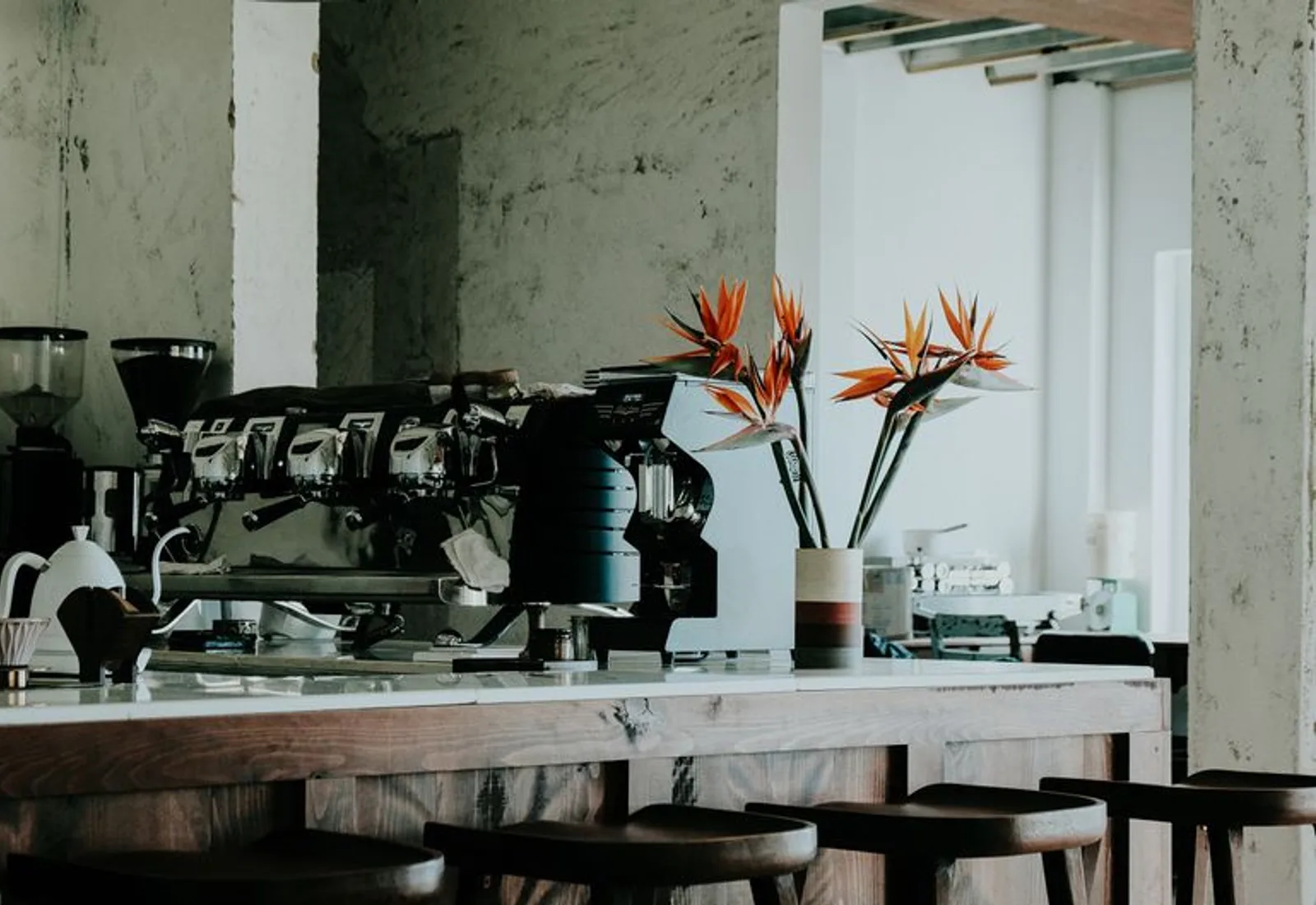 The café bar mid-service, espresso machines and morning light