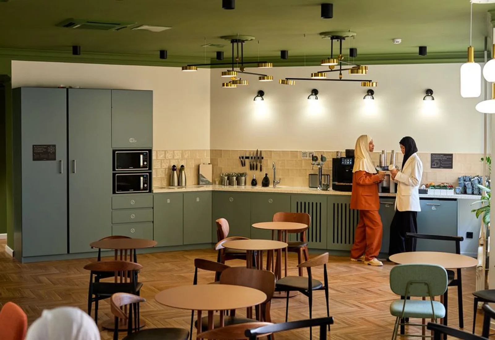 A bright office kitchen with a brewer on the counter